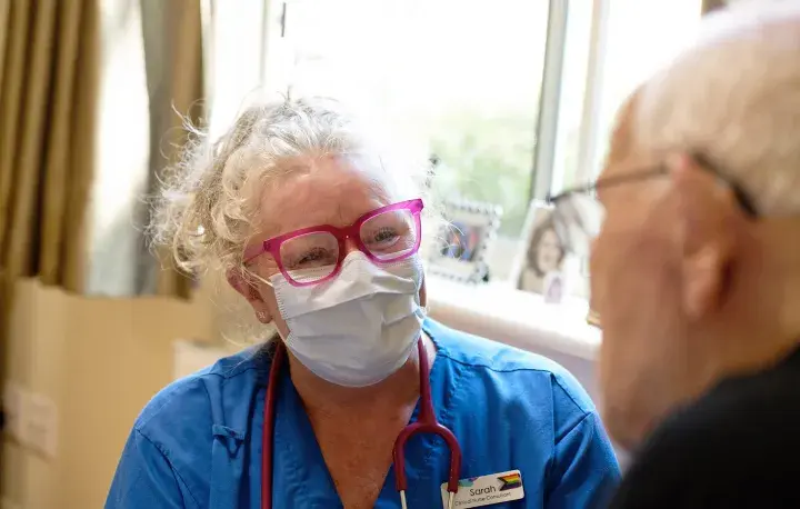 Western Health staff member smiling with a consumer 