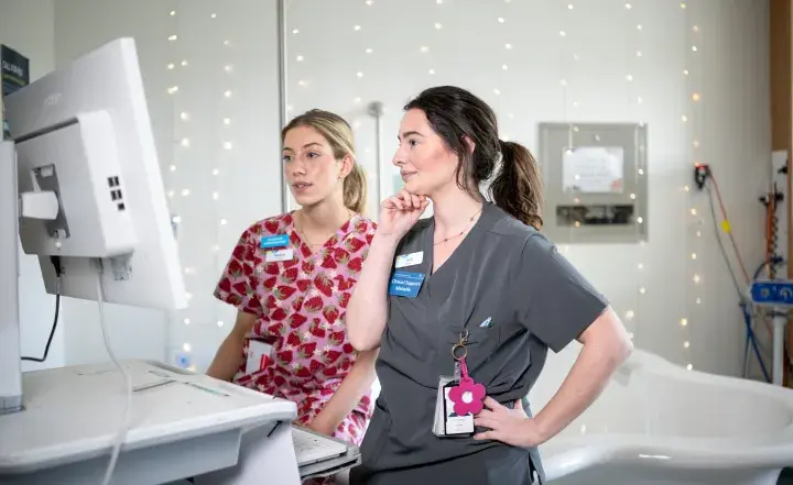 Western Health staff looking at a monitor in a hospital setting